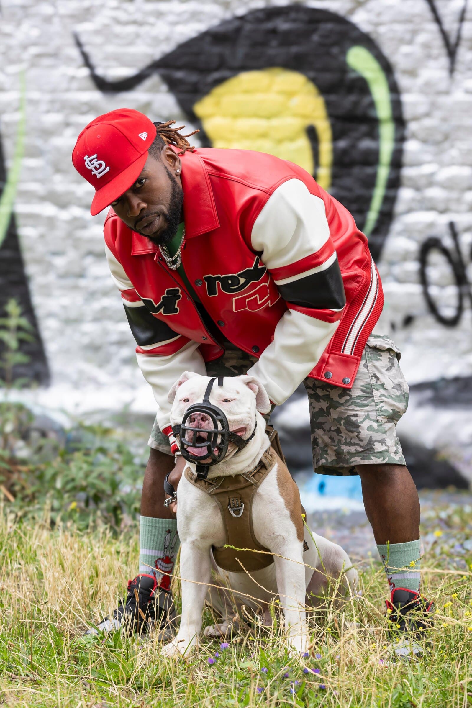 Vic Santoro crouching with his dog