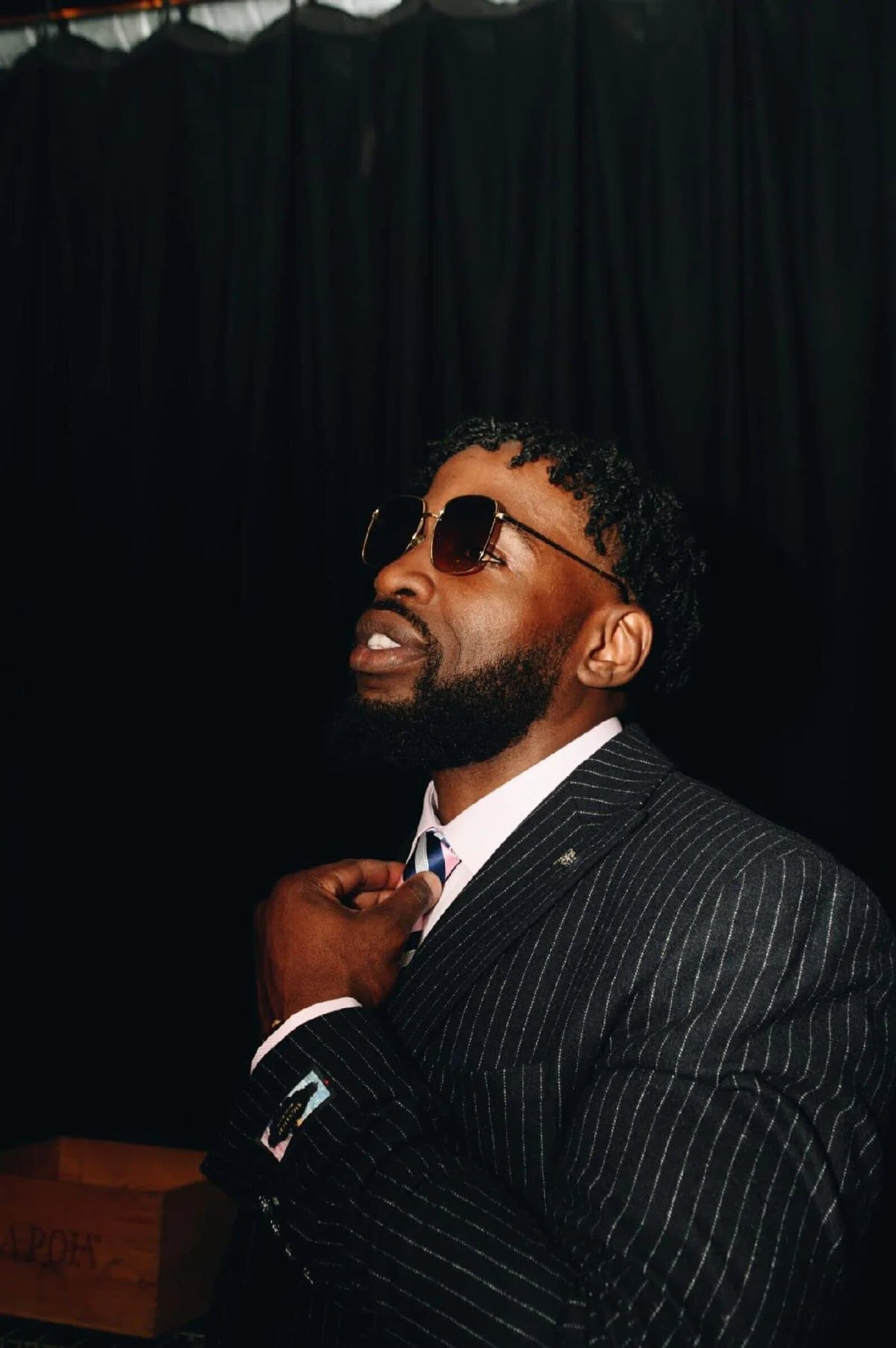Vic Santoro in a pinstripe suit and sunglasses